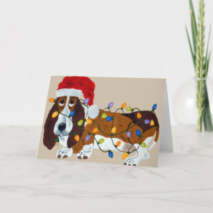 Dachshund verwirrt in den Weihnachtslichtern Feiertagskarte