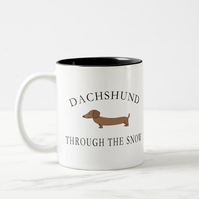Dackel durch den Schnee Zweifarbige Tasse (Links)