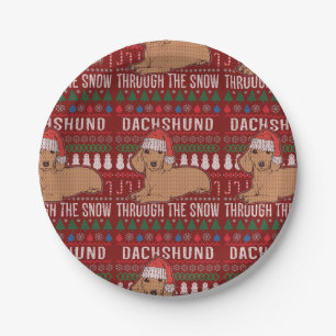 Dackel durch den schneebedeckten Weihnachtssüßer Pappteller