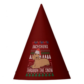 Dackel durch den schneebedeckten Weihnachtssüßer Partyhütchen