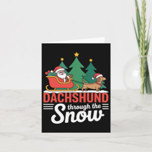 Dackel durch den schneefestlichen Weihnachtsfeiert Karte