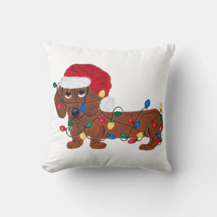 Dackel in Weihnachtslichter verheddert Kissen