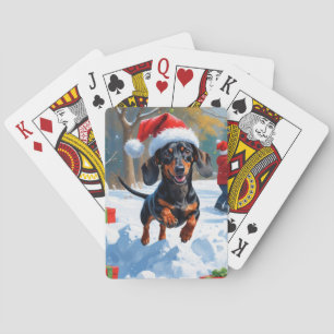 Dackel läuft im Schnee mit Weihnachtshut Spielkarten