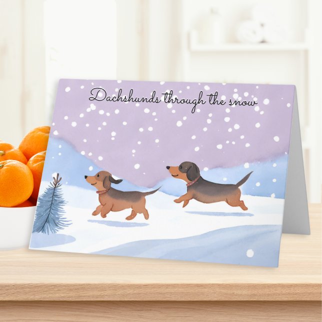 Dackeln durch die Schneeschuhwurst Weihnachten (A Christmas card with picture of two cute sausage dogs and caption 'Dachshunds through the snow')