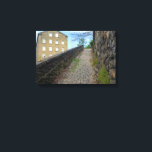 Dean Clough Cobblestone Climb - Brandt's Spirit  Leinwanddruck<br><div class="desc">Ascend a charming, overgrown cobblestone path in Dean Clough, Halifax, where historic industrial architecture meets the subtle vibrancy of nature. This image, while inspired by the evocative work of Bill Brandt, brings a fresh perspective with its natural colors, highlighting the subtle greens of the moss and the warm tones of...</div>