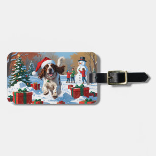 Der englische Setter läuft im Schnee mit Weihnacht Gepäckanhänger