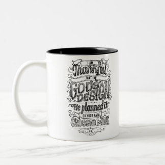 Der Entwurfs-Handmit buchstaben gekennzeichnetes Zweifarbige Tasse