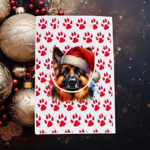 Deutscher Schäferhund in der Weihnachtsmannmütze W Mittlere Geschenktüte