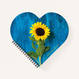 Dicke gelbe Sonnenblume auf blau Notizbuch