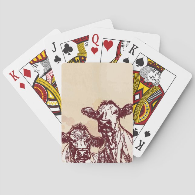 Die Hand mit zwei Kühen zeichnen die Skizze u. Spielkarten (Rückseite)