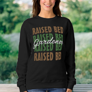 Die Pflanze, die den aufgehobenen Bettgärtner über Sweatshirt
