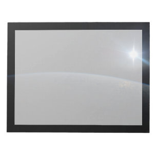 Die Sonne liegt über dem Horizont der Erde. Notizblock