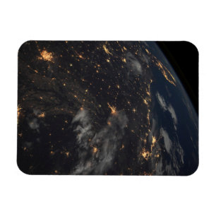 Die Stadt beleuchtet nachts auf der Erde Magnet