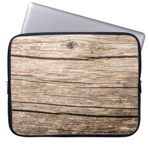 Die Struktur eines alten Holzbügels ohne Rinde mit Laptopschutzhülle