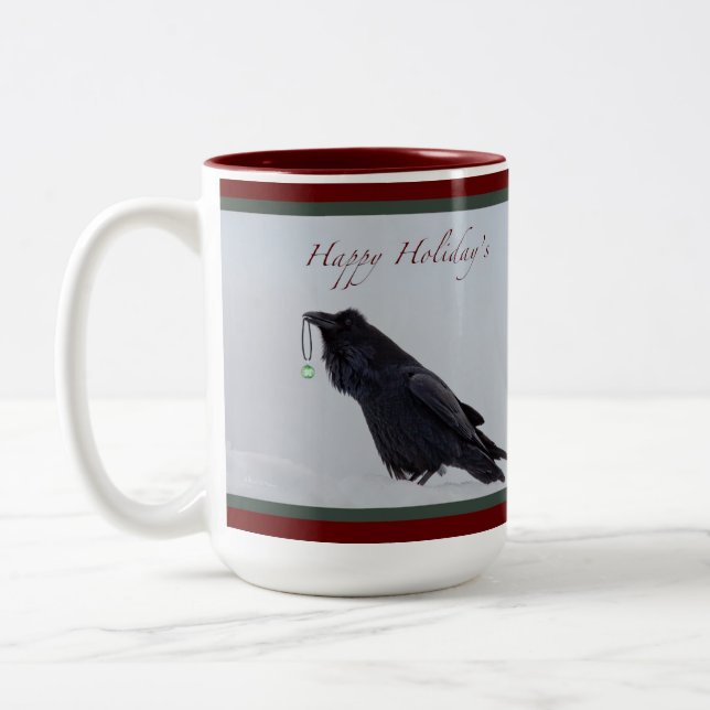 Die Tasse des Raben-glücklichen Feiertags (Links)