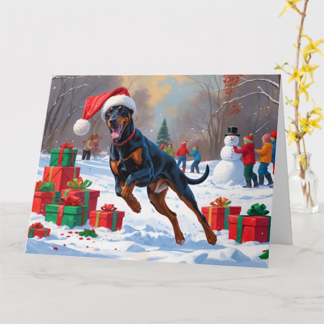 Doberman läuft im Schnee mit Weihnachtshut Karte (Gelbe Blume)