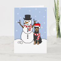 Dobermann-Pinscher und Schneemann
