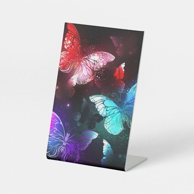 Drei glühende Schmetterlinge im Hintergrund Sockelschild (Vorderseite)