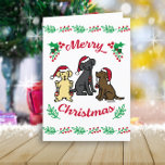 Drei Labradoren und Ornamente Weihnachten<br><div class="desc">Drei Labradors und Ornamente Weihnachtskarte für Labrador Retriever Besitzer. Sehr niedliches Labrador Retriever Cartoon Design mit drei Labradoren genießen Weihnachtsmannmützen und Ornamente. Die gelbe Labrador Retriever und der schwarze Labrador Retriever und Schokolade Labrador Retriever sind lackiert. Mischous Labrador-Ausdrücke und Rot- und Grünfarben bilden festliche Gefühle.</div>