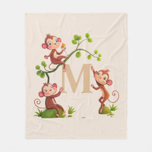 Drei niedliche Affen und goldenes Monogramm auf El Fleecedecke