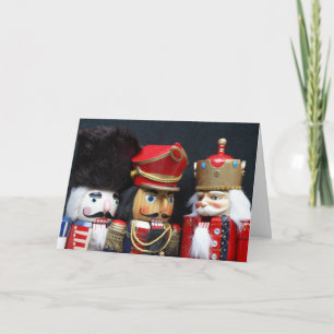 Drei Nussknacker auf der schwarzen Weihnachtskarte Feiertagskarte