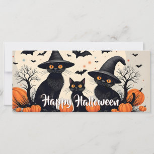 Drei schwarze Katzen mit Hüten an Halloween