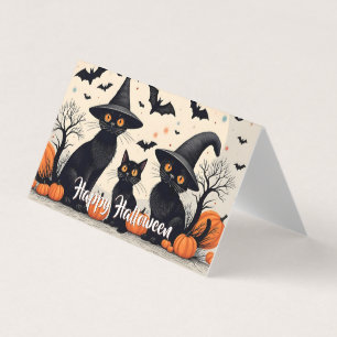 Drei schwarze Katzen zu Halloween