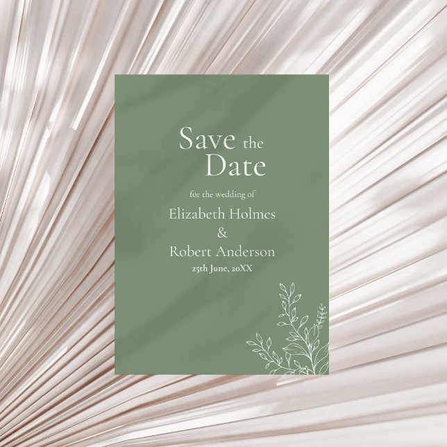 Dunkelgrüne Botanik-Save-the-Date-Karte Einladung (Dark Sage Green Botanical Save the Date Invitation on a neutral dry palm leaf.)