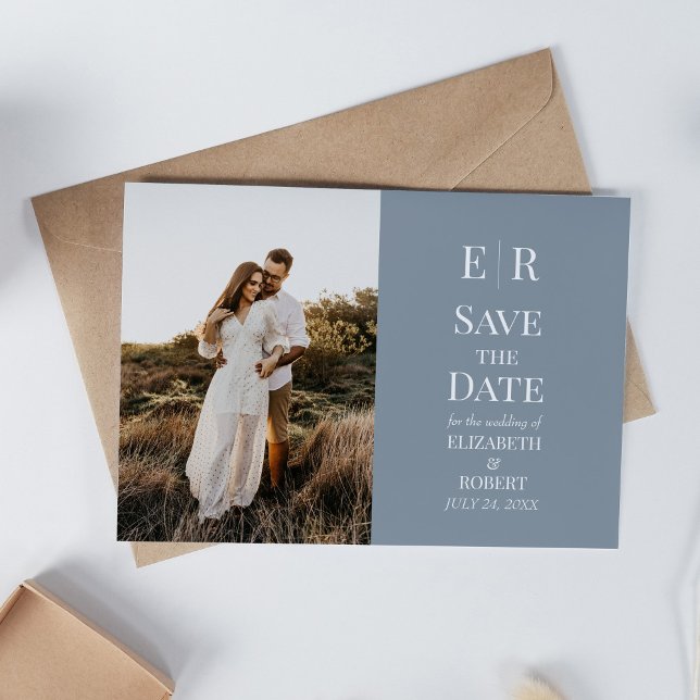 Dusty Blue Monogram Custom Foto Save the Date Einladung (Dusty Blue Monogram Custom Photo Save the Date Invitation on a white table with neutral decoration)