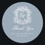 Dusty Blue Monogram Wedding Crest Thank You Runder Aufkleber<br><div class="desc">These elegant classic dusty blue wedding monogram thank you stickers are perfect for favors, place cards, and more. They feature an ornate vintage crest with intertwined fancy script calligraphy monogram, and script Thank You. Find matching products in the collection, or message me through Zazzle Chat for more products and design...</div>