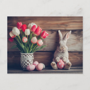 Easter bunny seated beside colorful eggs and tulip postkarte