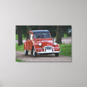 Ein alter roter Citroen 2CV Wagen mit einer lächel Leinwanddruck