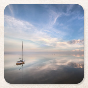 Ein einziges Segelboot auf dem ruhigen Wasser von Rechteckiger Pappuntersetzer