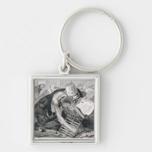 Ein gelehrter Mann absorbiert im Koran Schlüsselanhänger