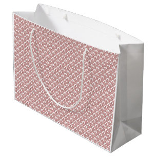 Ein gemusterter Teppich mit roten und braunen Moti Große Geschenktüte