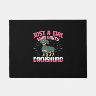 Ein Mädchen, das Dachshund liebt Fußmatte