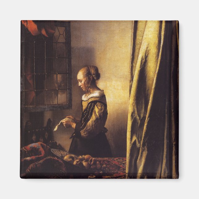 Ein Mädchen, das einen Buchstaben in einem offenen Magnet (Vorne)