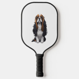 Ein niedlicher Hund König Charles Spaniel Pickleball Schläger