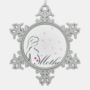 Ein schwangeres Mutter-zu-ist mit rosa Schneeflocken Zinn-Ornament