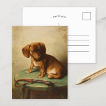 Eine Dackel Welpe | Carl Reichert Postkarte<br><div class="desc">Dackel Welpe (1888) | Carl Reichert’s A Dackel Puppy ist ein hübsches Portrait mit einem kleinen braunen Dackel Welpe, der auf einem Holzhocker steht. Das Kunstwerk erfasst den eigenartigen und unschuldigen Ausdruck des Welpen mit exquisiten Details, von der weichen Textur seines Pelzes bis hin zur subtilen Schattierung seiner Umgebung. Set...</div>
