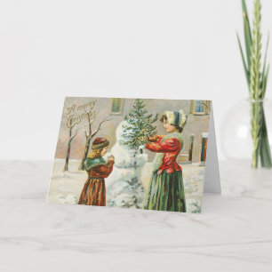 Eine frohe Weihnachtsfrau, ein Kind und ein Snowma Feiertagskarte