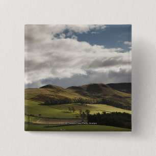 Eine Landschaft mit Rolling Hills und Wolken Button