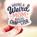 Eine merkwürdige Mama baut Charakter Funny Vinyl Aufkleber<br><div class="desc">Feiern Sie Ihre verrückte Mutter mit diesem lustigen und zuverlässigen Aufkleber! Dieser Aufkleber mit der Phrase "Eine merkwürdige Mama baut Charakter" in spielerischem Design ist eine leichtere Hommage an alle Mütter, die ihre einzigartige Persönlichkeit annehmen und das Leben interessanter machen. Dieser Aufkleber aus haltbarem Vinyl eignet sich perfekt für Laptops,...</div>