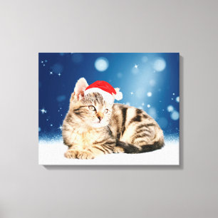 Eine Niedliche Katze, die einen Weihnachtsschnee i Leinwanddruck