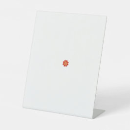 eine rot-gelbe Blume mit schwarzen Punkten Sockelschild