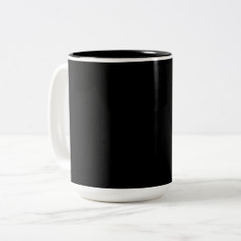 Eine strukturierte schwarze Oberfläche mit feinem  Zweifarbige Tasse