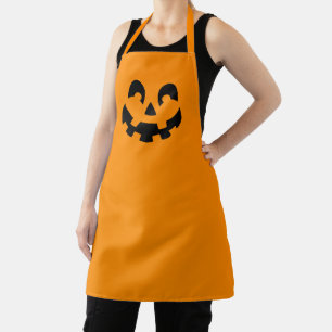 Einfache schwarze Kürbisgesicht an orangefarbenem Schürze