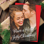 Elegant Festive Holly Jolly Weihnachts-Script-Foto Feiertagskarte<br><div class="desc">Diese hübsche Urlaubsfotokarte enthält einen Gruß mit weißer Kalligrafie-Schrift, in dem steht: "Habe einen Holly Jolly Weihnachten" über einem vertikalen Foto (auch als "Vollblut" bezeichnet). Auf der Rückseite der Karte befindet sich ein koordinierendes graues und weißes diagonales Streifen-Muster. Fügen Sie ein anderes Foto und/oder einen zusätzlichen Text hinzu, indem Sie...</div>