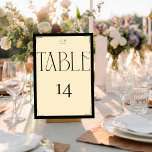 Elegant Serif Black Cream Monogram Table Number Tischnummer<br><div class="desc">Make a grand statement at your next event with these Art Deco-inspired table cards, showcasing a striking contrast of black and beige. The captivating script font for 'TABLE' and the bold number '14' exude vintage charm and sophistication. These cards are designed not only to direct your guests but also to...</div>