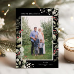 Elegant Winter Greenery Botanical Black One Photo Feiertagskarte<br><div class="desc">This elegant holiday photo card features a single vertical photo framed by beautiful watercolor eucalyptus, holly, and berries over a chic black background. The editable greeting on the front says "Happy Holidays". The back of the card is a coordinating foliage pattern, which can be removed if desired. You can also...</div>